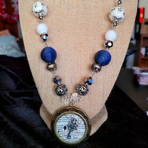 Women's Locket necklace with blues and whites.